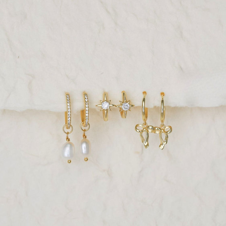 sterling silver earrings hanging on paper 