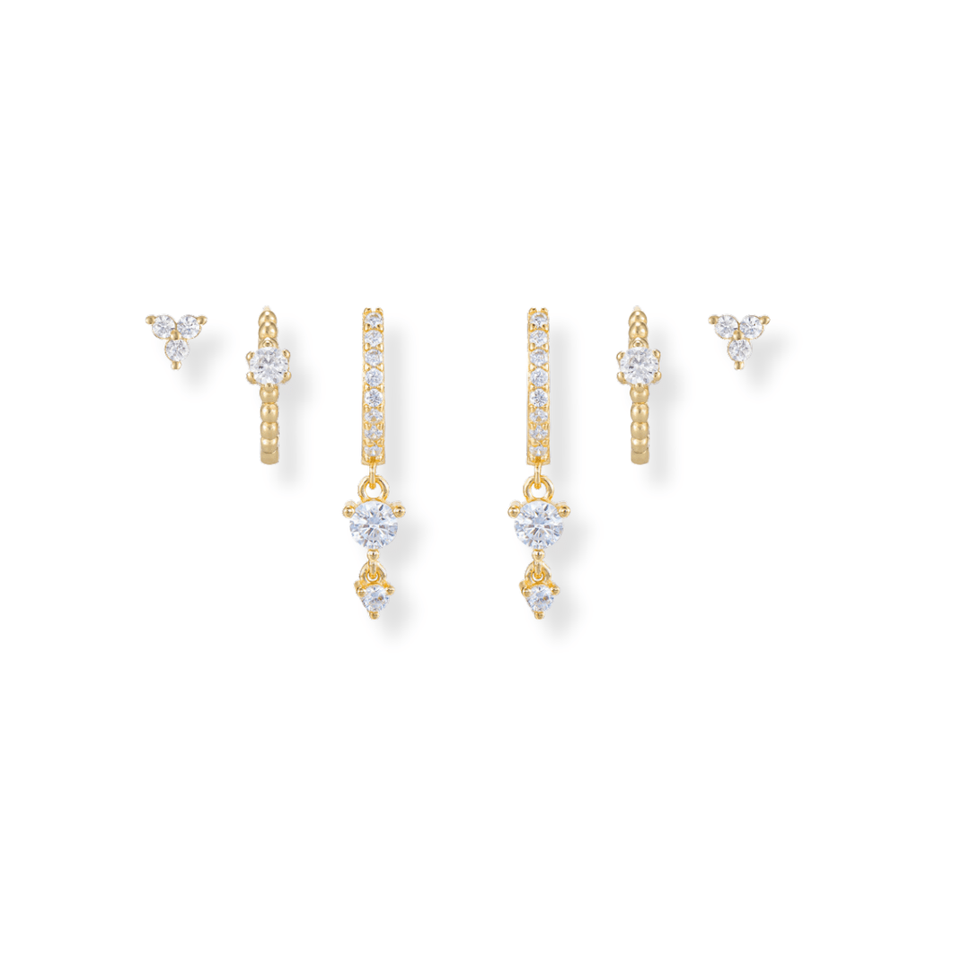 sparkly gold Earring Stack featuring cz huggie drops, cz huggies and trio diamond studs 