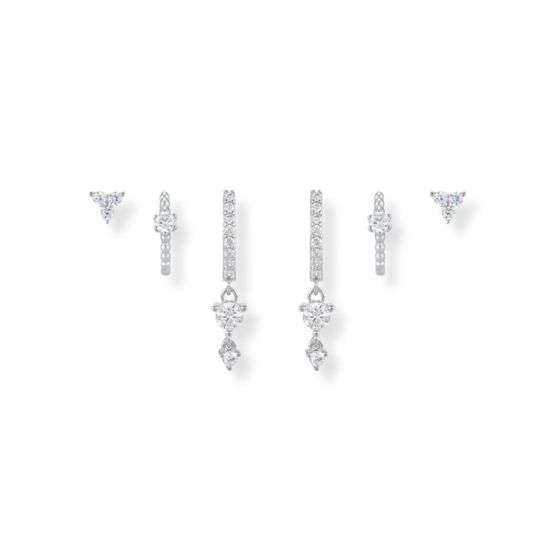 Sparkly silver Earring Stack featuring cz huggie drops, cz huggies and trio diamond studs 