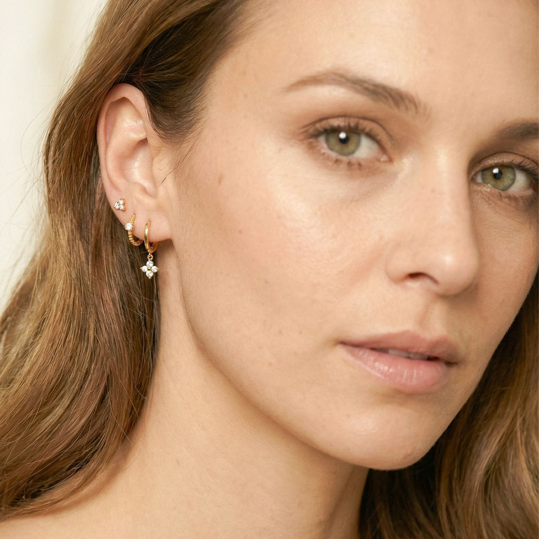 Freya Gold Flora Drop Huggie Earrings in a stack on model
