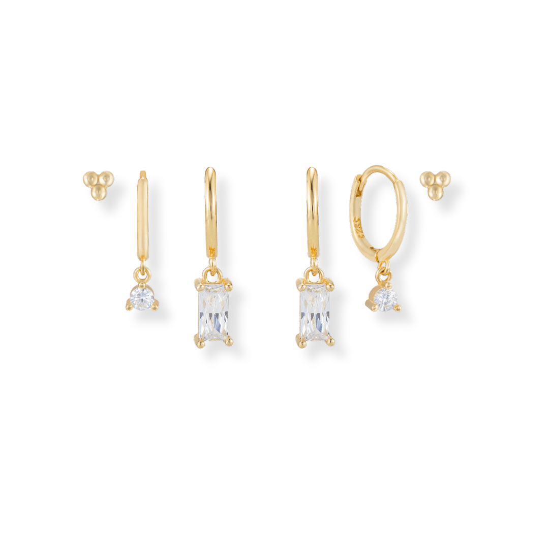 sparkly gold Earring Stack featuring Baguette drops, dainty cz drops, triple ball studs