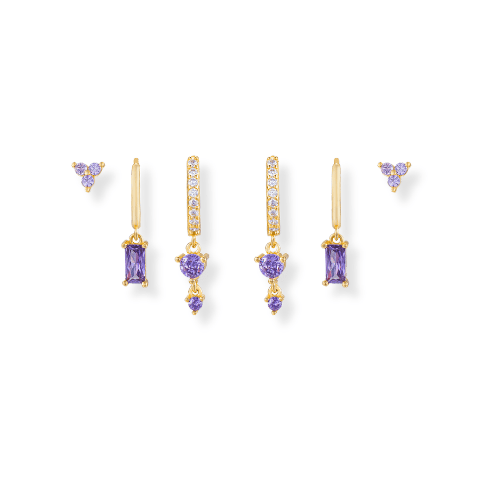  Purple Earring Stack in gold featuring cz huggie drops, Baguette drops, trio cz studs all with purple cz stones