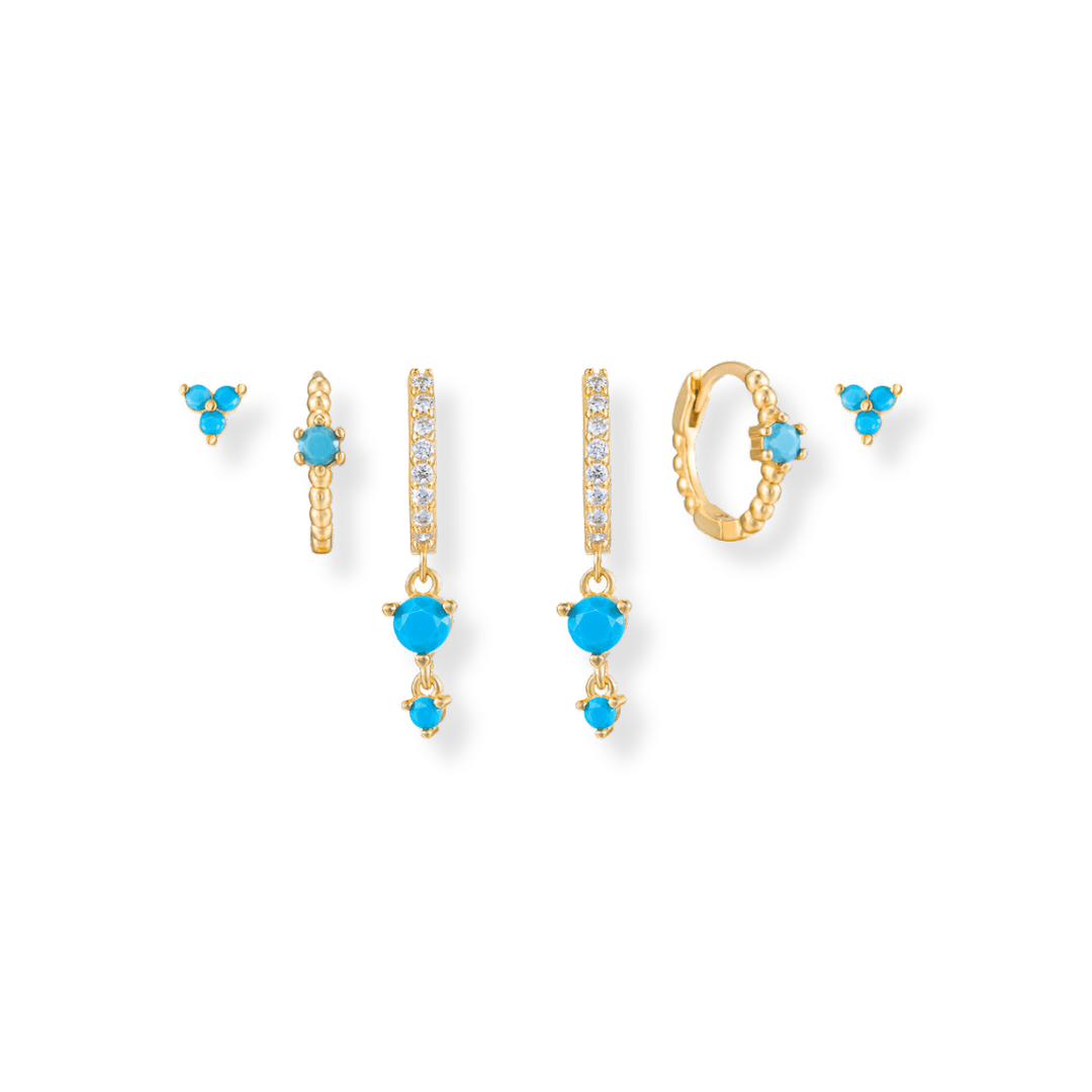 Turquoise Earring Stack in gold featuring turquoise hoop drops, turquoise huggies and turquoise trio cz studs 