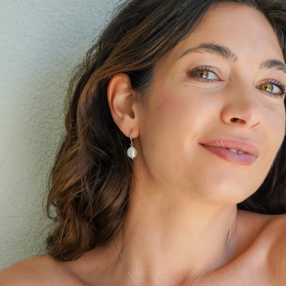 Freshwater Pearl Drop Huggie Earrings Sterling Silver on model