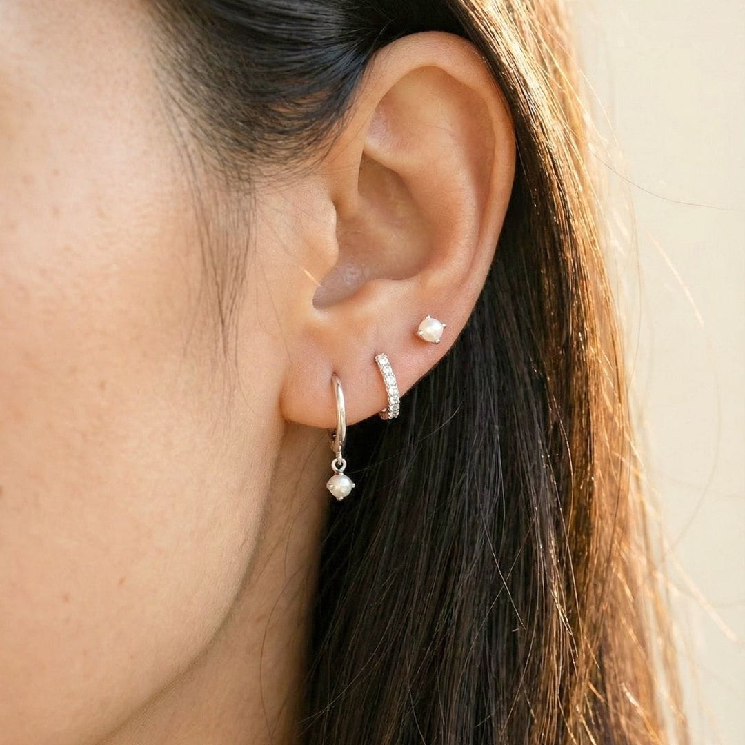 silver earring stack: pearl drop, pave huggie, pearl stud