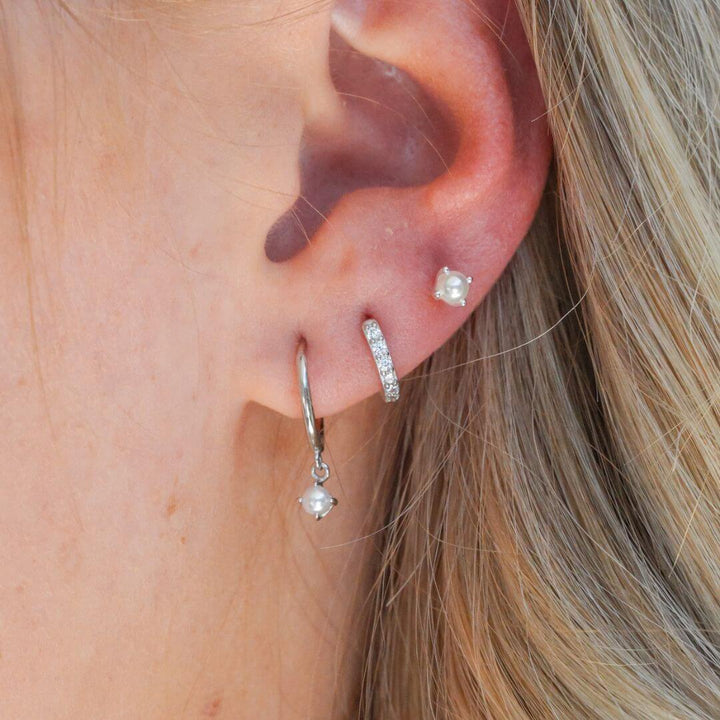 Sterling Silver Huggie Hoop Earrings 8MM in an ear stack
