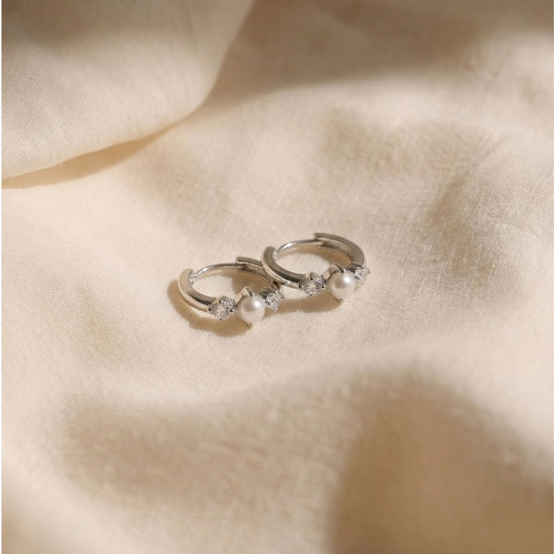 Vivek Silver Pearl Huggie Earrings Flat Lay