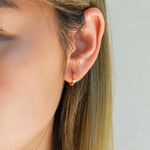 Huggie Earrings with CZ stud Gold on model