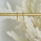  Dainty Pearl Drop Huggie Earrings Gold on display